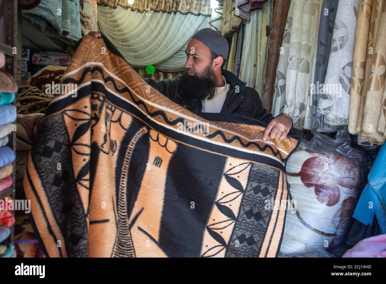 Indian male selling traditional African blankets in Johannesburg, South Africa Stock Photo