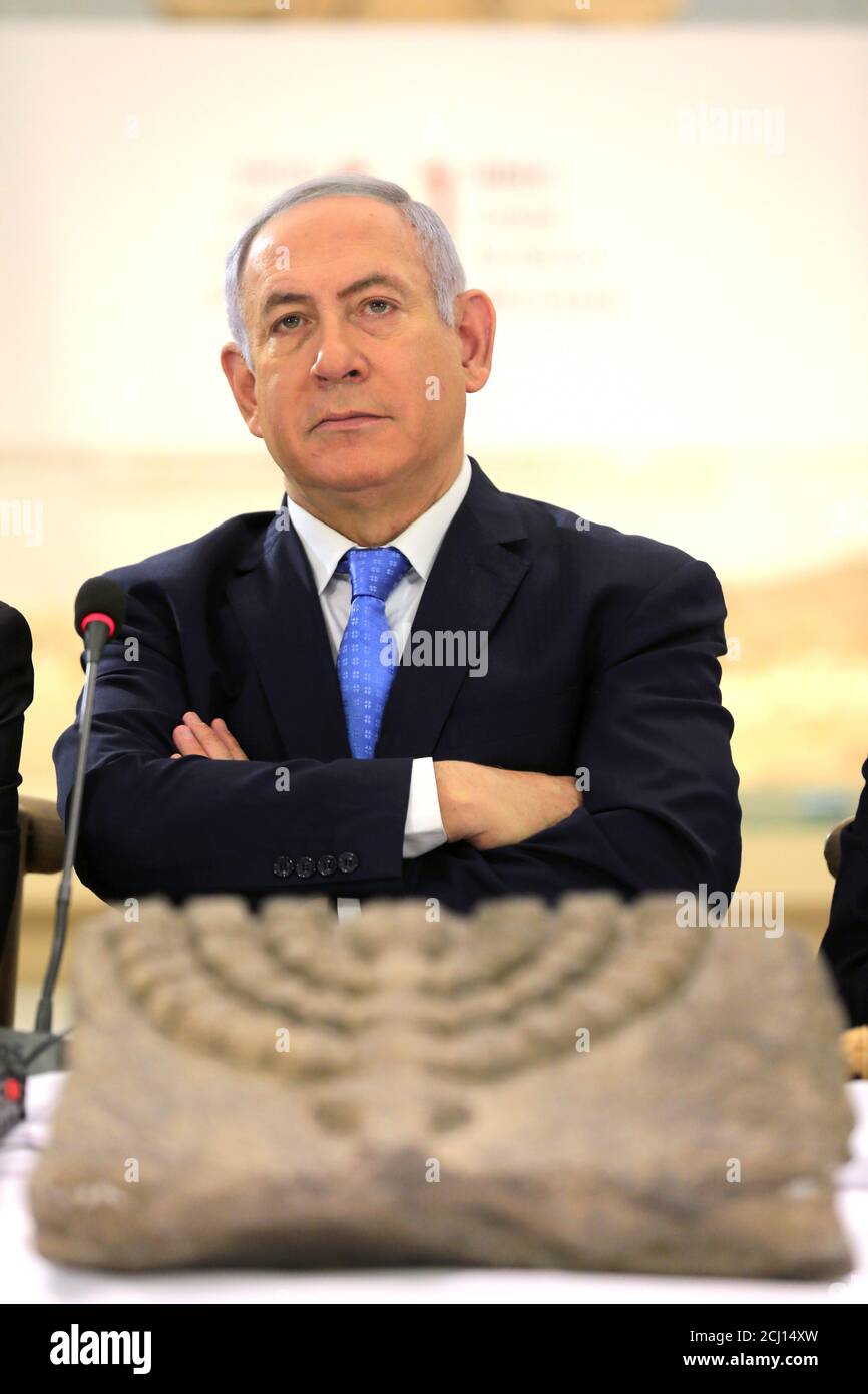 Israeli Prime Minister Benjamin Netanyahu sits behind an archeological artifact displaying a menorah, the ancient symbol of Judaism, during a special cabinet meeting marking Jerusalem Day, at the Bible Lands Museum in Jerusalem May 13, 2018. REUTERS/Amir Cohen/Pool Stock Photo