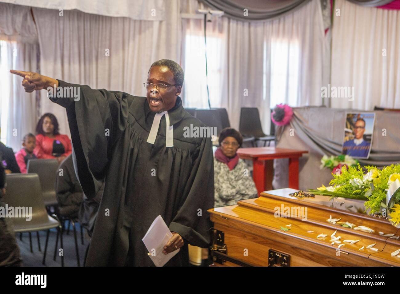African christian priest giving a sermon at a funeral in Soweto
