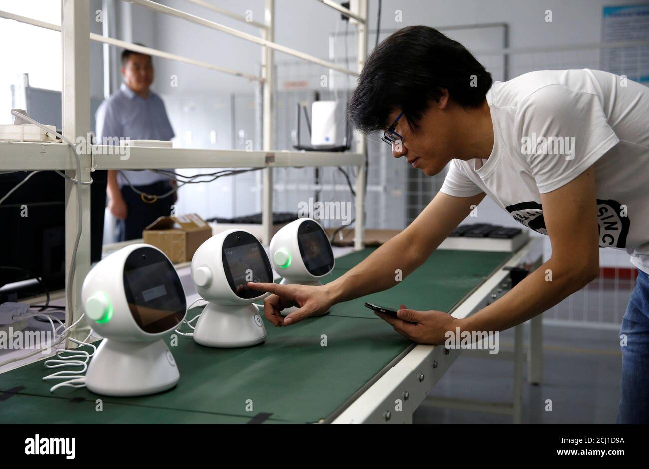 An engineer tests a "Xiaoyi" robot, a Siri-like voice assistant, which  links the user to Lanchuang's intelligent elderly care system, at the  headquarters of Lanchuang Network Technology Corp in Weifang, Shandong  province,