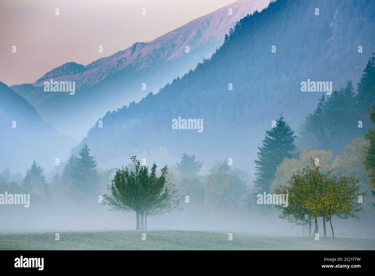 fog in mountain valley in Nauders, Italy, South Tyrol, Dolomites Stock Photo