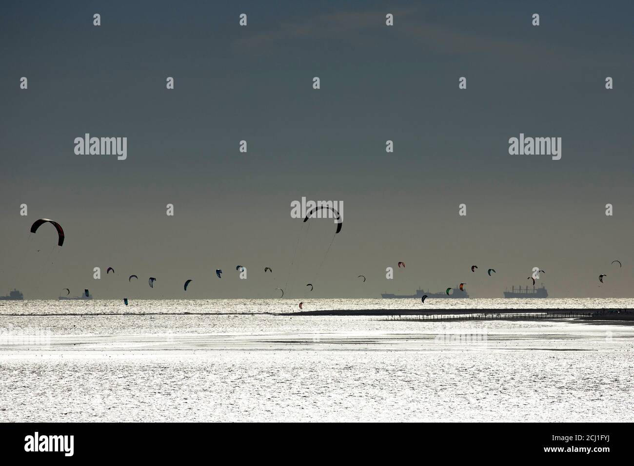 Kite surfing on the beach with thunder clouds, Netherlands, Zeeland, Maasvlakte, Oostvoorne Stock Photo