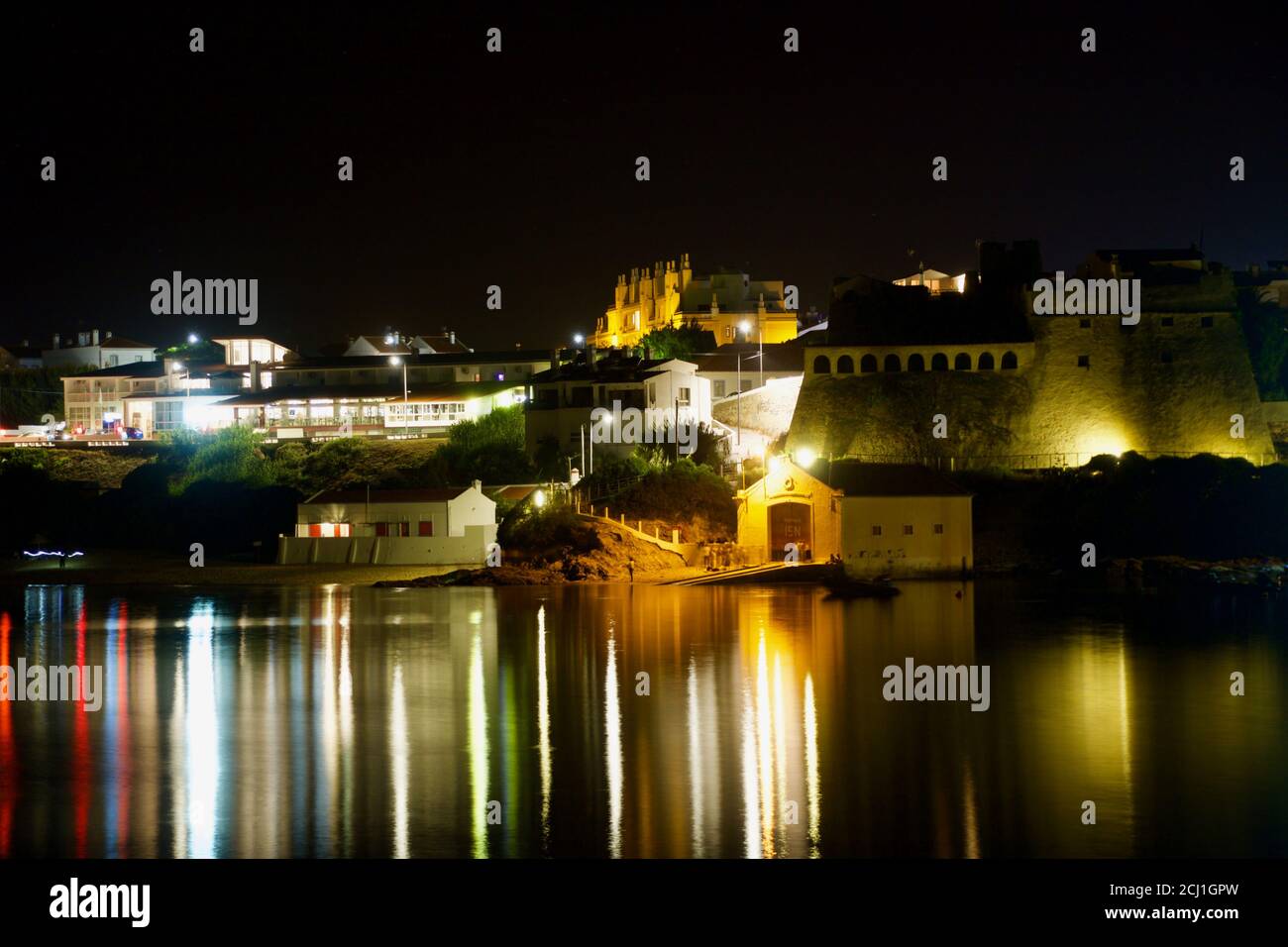 Night view of Vila Nova de Milfontes, Portugal, from the south bank to the north bank. Stock Photo