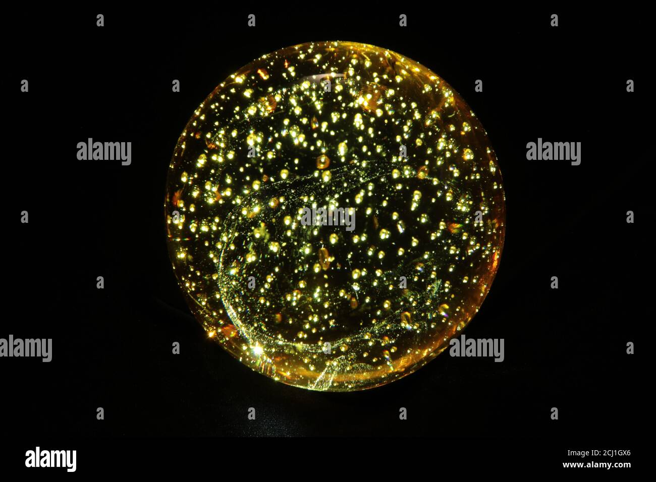 Transparent glass ball with dark background and lighting effects. Stock Photo