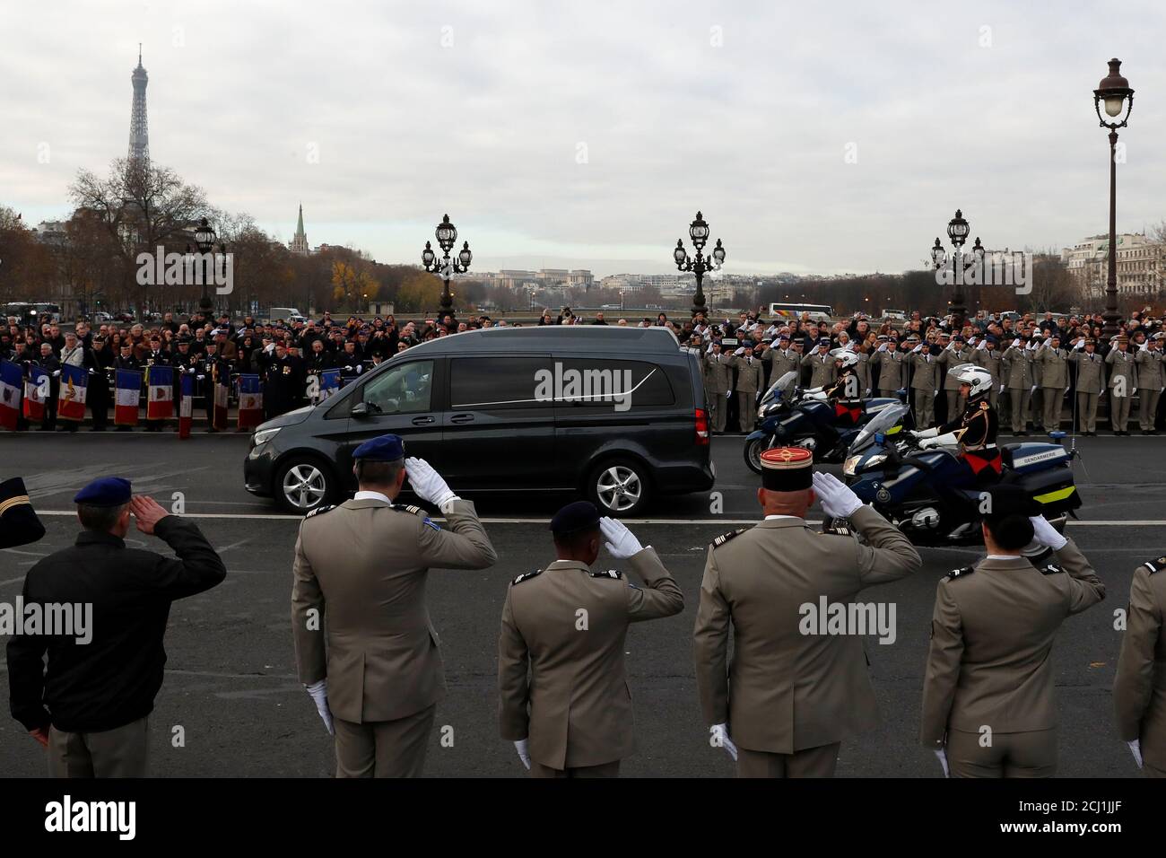 Soldiers and citizens pay tribute as hearses with the coffins of late thirteen French soldiers killed in Mali make their way past the Alexandre III bridge before a ceremony at the Hotel National des Invalides in Paris, France, December 2, 2019. French soldiers Julien Carrette, Benjamin Gireud, Romain Salles de Saint-Paul, Clement Frison-Roche, Nicolas Megard, Romain Chomel de Jarnieu, Pierre Bockel, Alex Morisse, Jeremy Leusie, Alexandre Protin, Antoine Serre, Valentin Duval, Andrei Jouk died in Mali when their helicopters collided in the dark last week as they hunted for Islamist militants.   Stock Photo