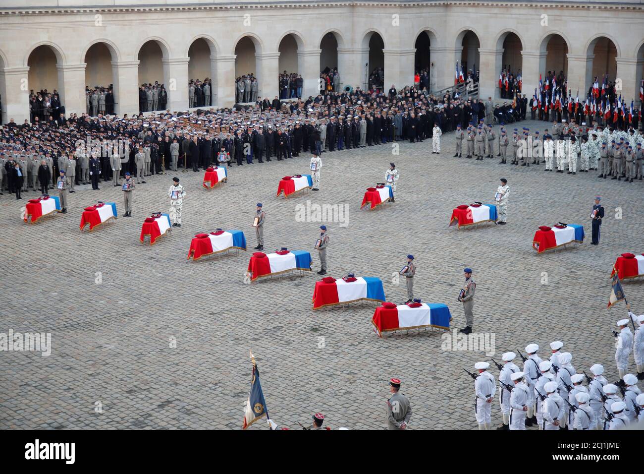 The flag-draped coffins of the thirteen French soldiers killed in Mali, are seen during a national ceremony at the Hotel National des Invalides in Paris, France, December 2, 2019. French soldiers Julien Carrette, Benjamin Gireud, Romain Salles de Saint-Paul, Clement Frison-Roche, Nicolas Megard, Romain Chomel de Jarnieu, Pierre Bockel, Alex Morisse, Jeremy Leusie, Alexandre Protin, Antoine Serre, Valentin Duval, Andrei Jouk died in Mali when their helicopters collided in the dark last week as they hunted for Islamist militants.  REUTERS/Charles Platiau Stock Photo