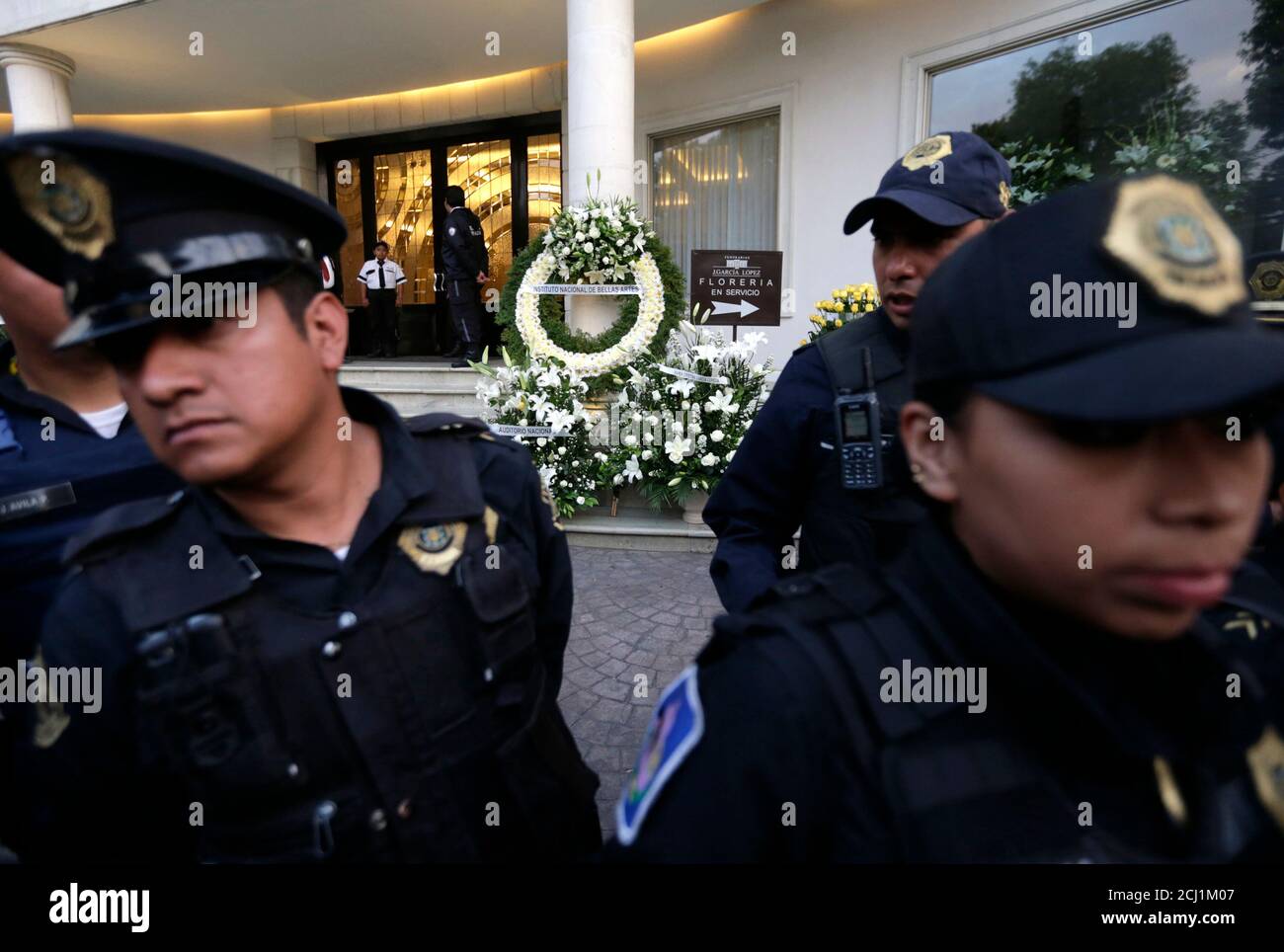 Police officers block the entrance to the funeral home where the body of Colombian Nobel Prize laureate Gabriel Garcia Marquez was taken to, in Mexico City April 17, 2014. Garcia Marquez, the Colombian author whose beguiling stories of love and longing brought Latin America to life for millions of readers and put magical realism on the literary map, died on Thursday. He was 87. Fans will pay their last respects to him in the Palace of Fine Arts in Mexico City on Monday and he will be cremated in a private ceremony. REUTERS/Henry Romero (MEXICO  - Tags: SOCIETY OBITUARY) Stock Photo