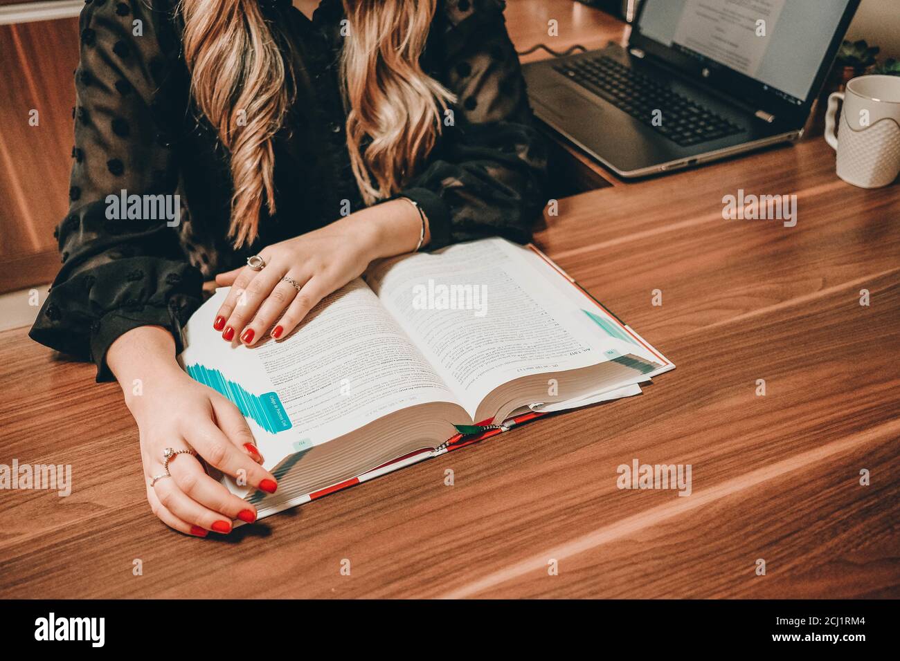 Female student reading a book and studying for the exams Stock Photo