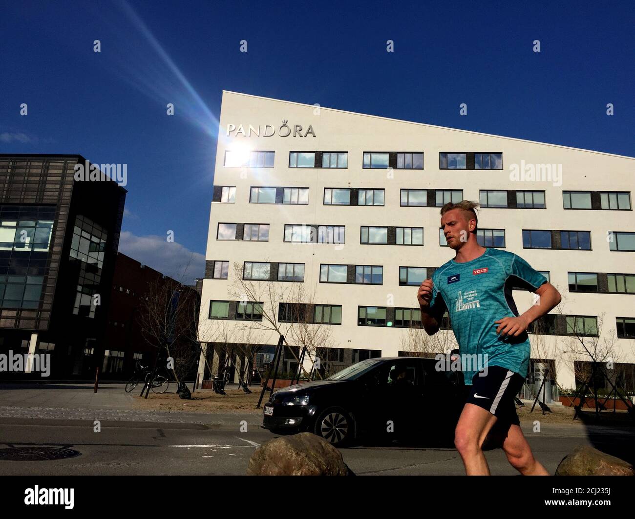 A man runs past Pandora headquarters in Copenhagen, April 8, Picture taken April 8, 2019. REUTERS/Jacob Gronholt-Pedersen Stock - Alamy