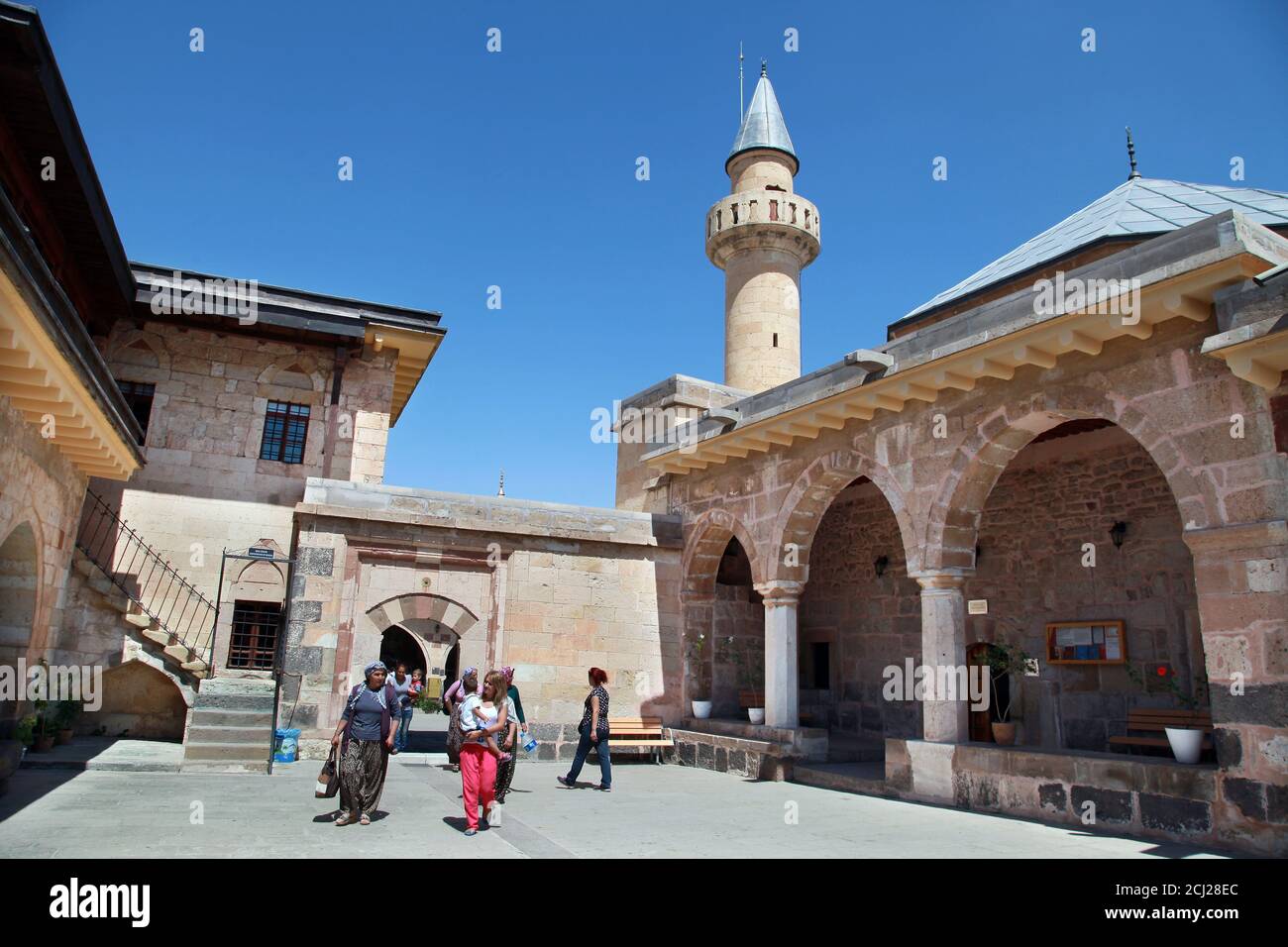 HACI BEKTAS, TURKEY - AUGUST 25: People visiting at famous mosque of Haci Bektas Veli on August 25, 2013 in Nevsehir, Turkey. Haci Bektas is the founder of the Bektashi order, lived in 14th century. Stock Photo