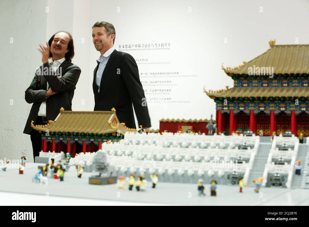 Danish Crown Prince Frederik and the head of the Danish Cultural Center Eric Messerschmidt stand next to a model of the Forbidden City made of Lego bricks in the Danish Cultural Center at the 798 art district in Beijing, China, September 23, 2017.   REUTERS/Thomas Peter Stock Photo