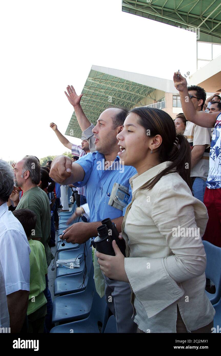 ISTANBUL, TURKEY - JULY 20: Horseracing fans watching the horse race at the tribune in Veliefendi Hippodrome on July 20, 2005 in Istanbul, Turkey. Stock Photo