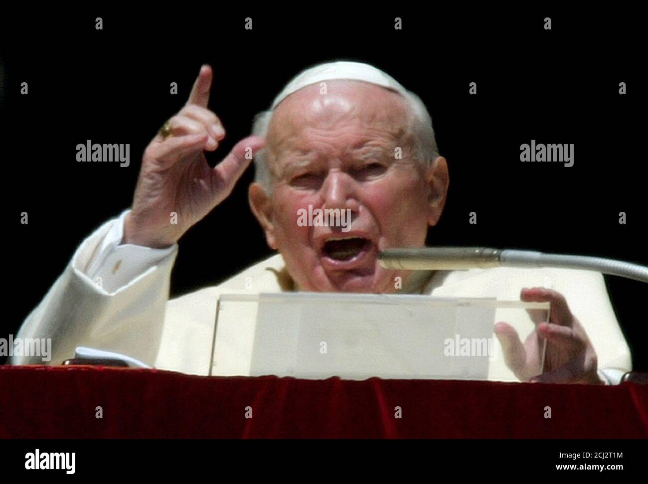 Pope John Paul II gestures during his Sunday blessing in Saint Peter's Square March 16, 2003.In a passionate plea for peace, Pope John Paul said on Sunday Iraq's leaders had a duty to cooperate with the international community to avert war and told both sides there was still time to negotiate. Departing at one point from his scripted Angelus address, he said that having lived through World War Two, he felt duty-bound to tell the world: 'Never again war'.  REUTERS/Max Rossi Stock Photo