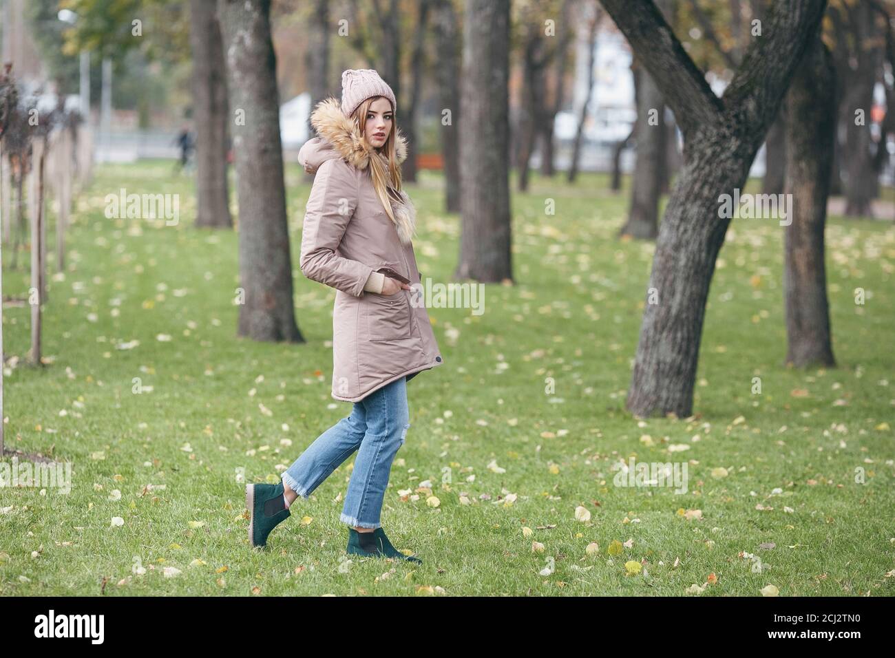 Young pretty woman walking in the autumn park Stock Photo - Alamy
