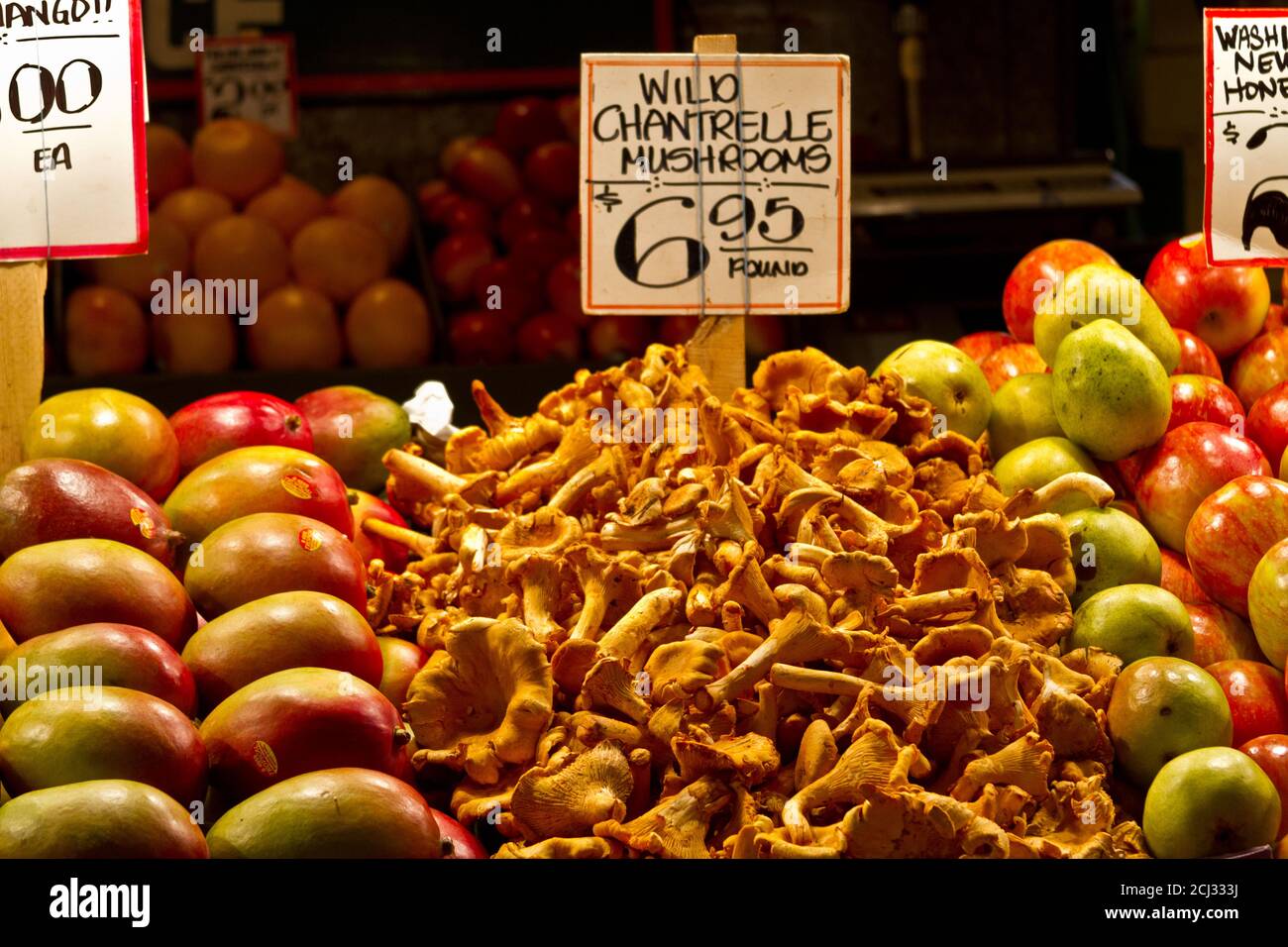 Organic apples and wild Chantrelle Mushrooms on display at Pike Market, Seattle, WA. Stock Photo