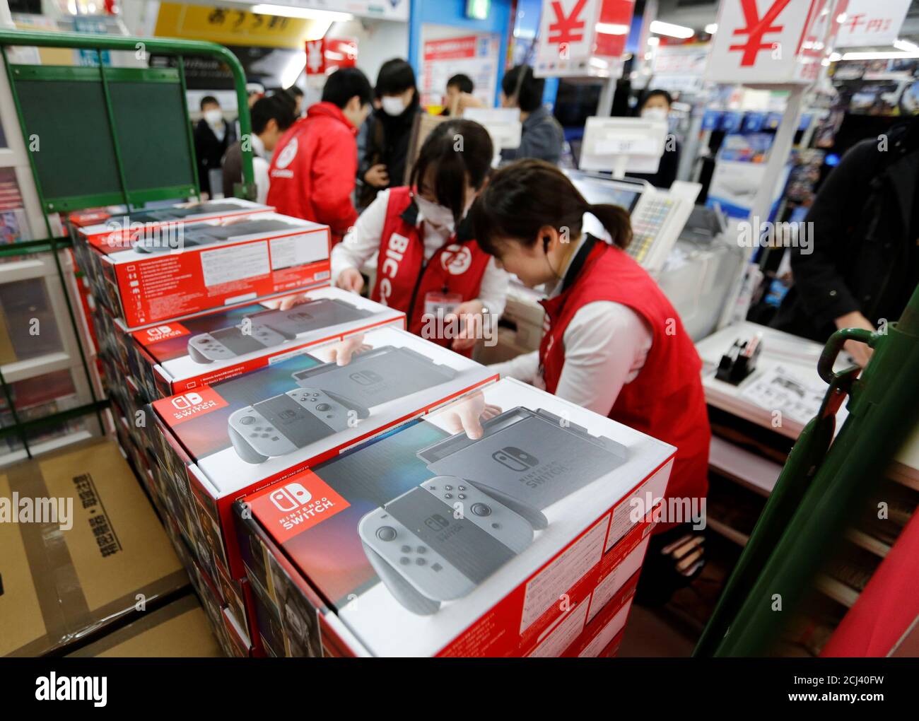 Sales staff work behind Nintendo Switch game consoles at an electronics  store in Tokyo, Japan March 3, 2017. REUTERS/Toru Hanai Stock Photo - Alamy