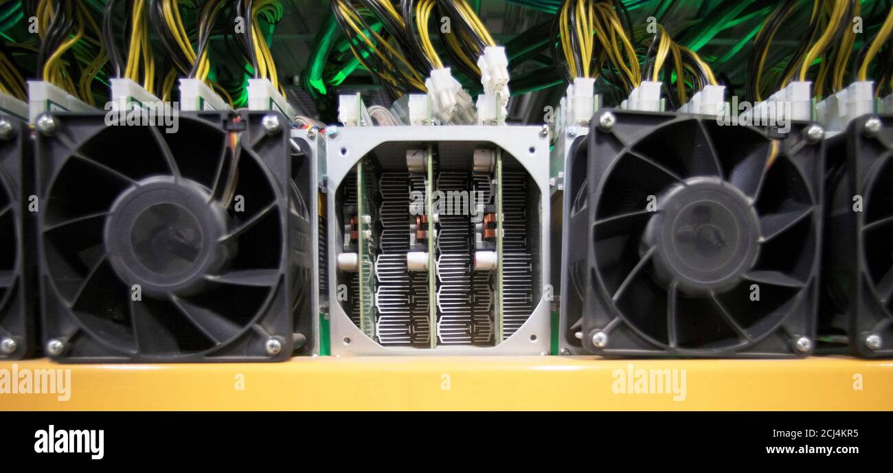 A miner waits to have its fan replaced, at the cryptocurrency farming operation, Bitfarms, in Farnham, Quebec, Canada, February 2, 2018. Picture taken February 2, 2018. REUTERS/Christinne Muschi Stock Photo