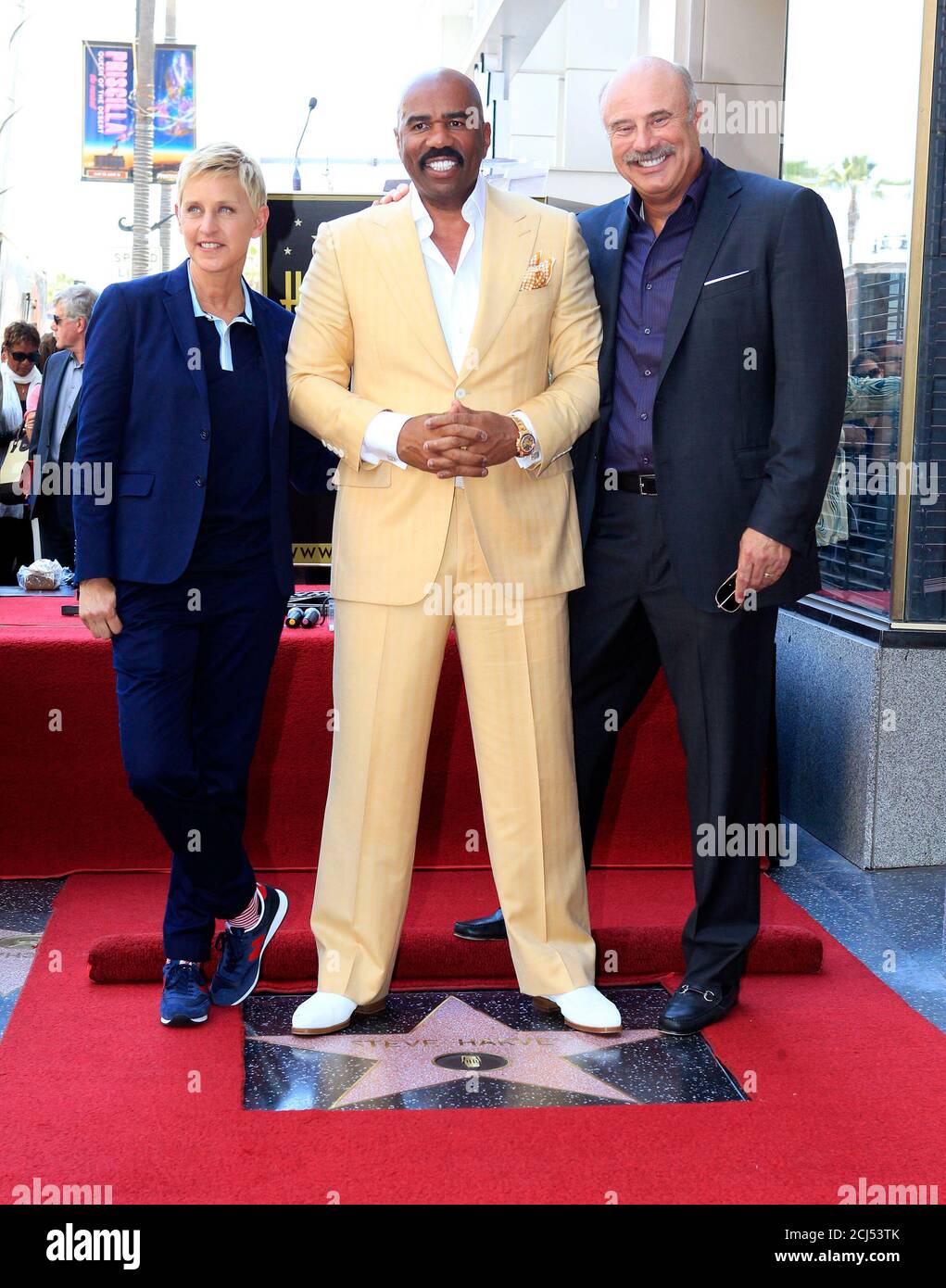 Comedian and actor Steve Harvey (C) poses with friends Ellen DeGeneres and  Dr. Phil McGraw, next to his newly unveiled star on the Hollywood Walk of  Fame in Hollywood May 13, 2013.