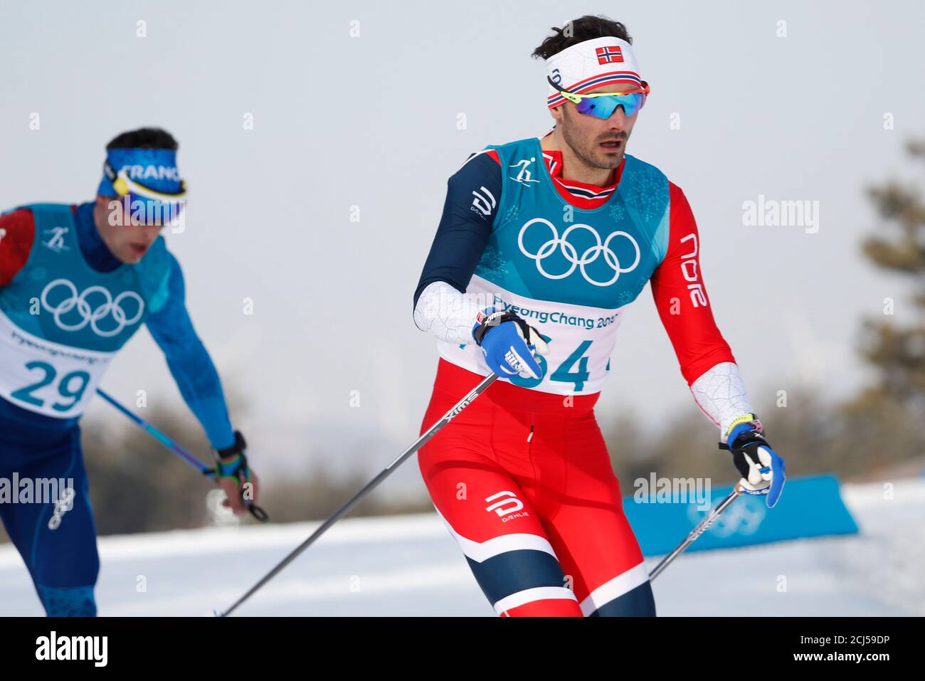 Cross-Country Skiing – Pyeongchang 2018 Winter Olympics – Men's 15km Free – Alpensia Cross-Country Skiing Centre – Pyeongchang, South Korea – February 16, 2018 - Hans Christer Holund of Norway and Adrien Backscheider of France compete. REUTERS/Murad Sezer Stock Photo