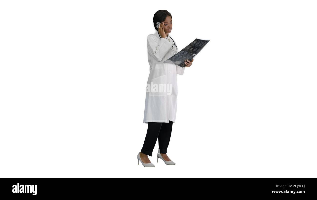 Female medical doctor reading x rays of patients brain on white Stock Photo
