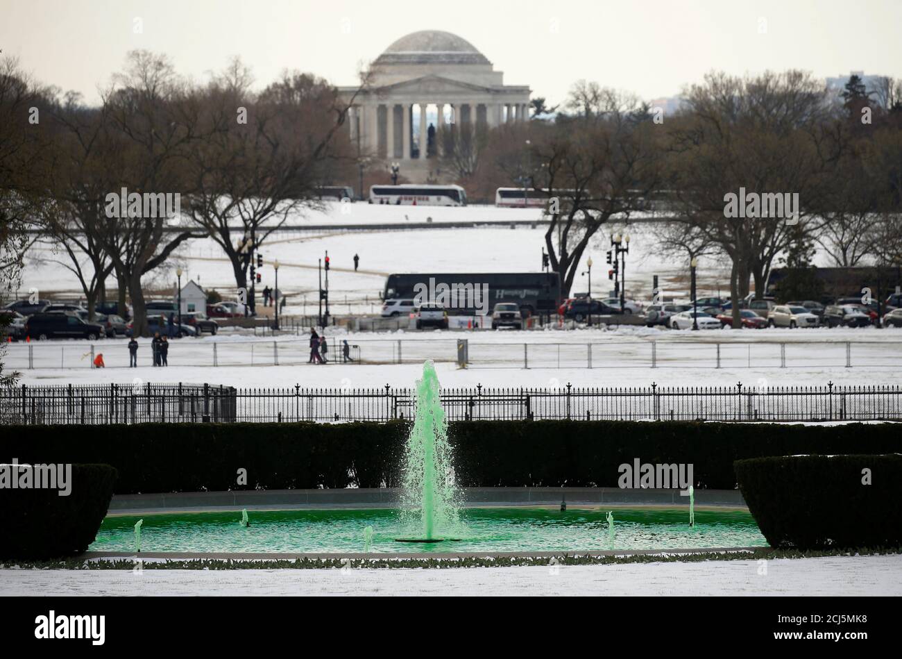 With the Jefferson Memorial in the background, the fountain on the South Lawn of the White House is green in honor of St. Patrick's Day and the visit of Irish Taoiseach Enda Kenny to the White House in Washington, U.S., March 16, 2017. REUTERS/Kevin Lamarque Stock Photo