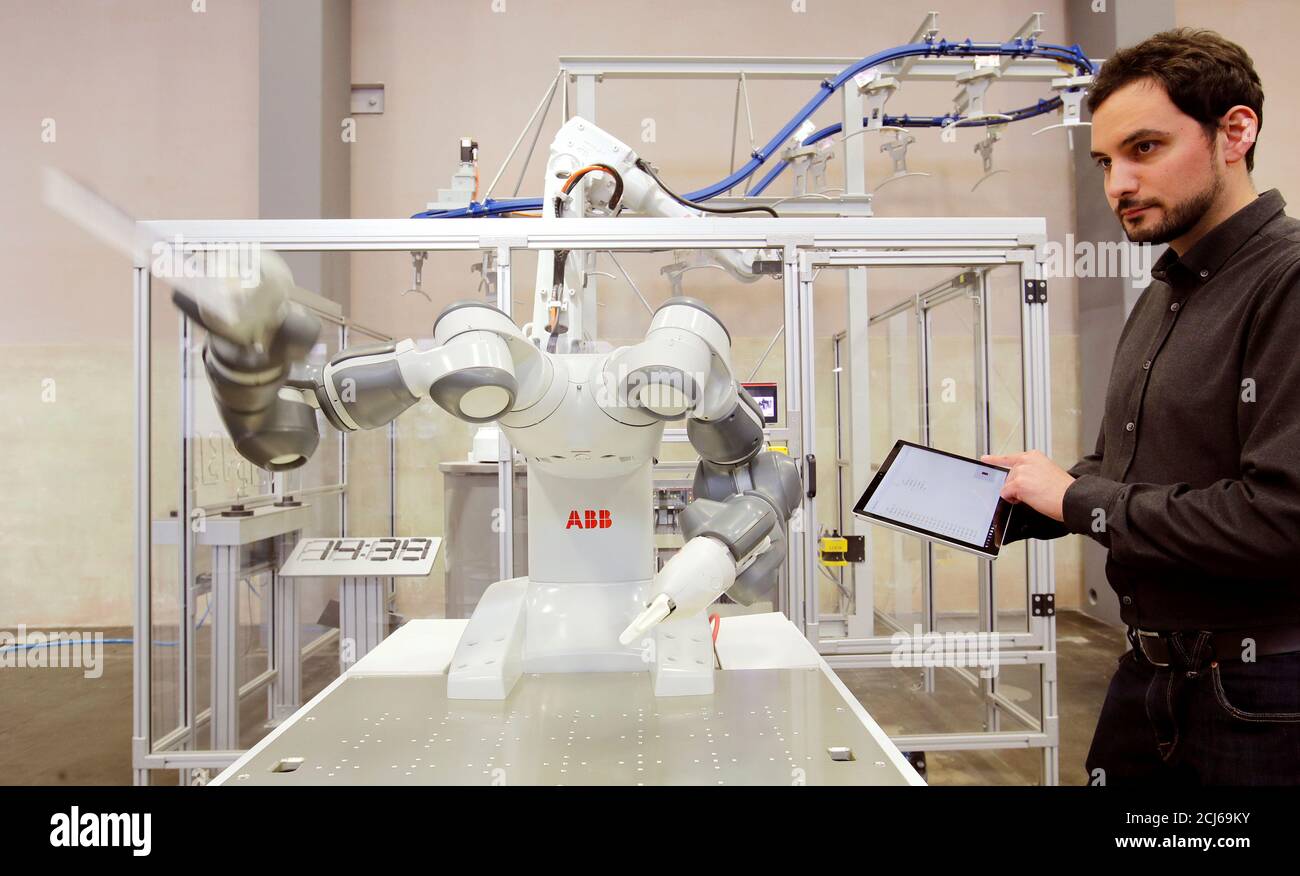 Engineer Manel Trilla of Swiss power technology and automation group ABB  checks a YuMi - IRB14000, a collaborative dual-arm industrial robot, of ABB  Robotics at a plant in Baden, Switzerland February 7,