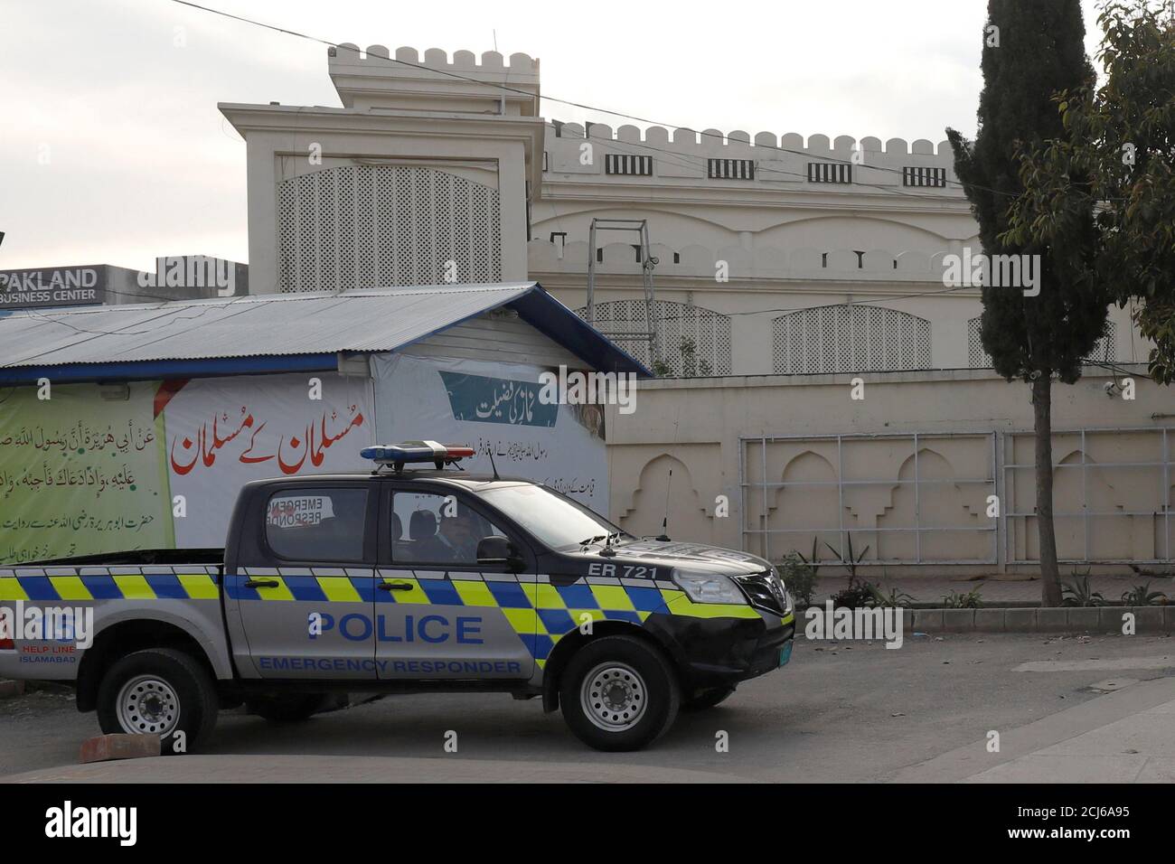 A police vehicle is seen in front of an office of Islamic charity  organization Jamaat-ud-