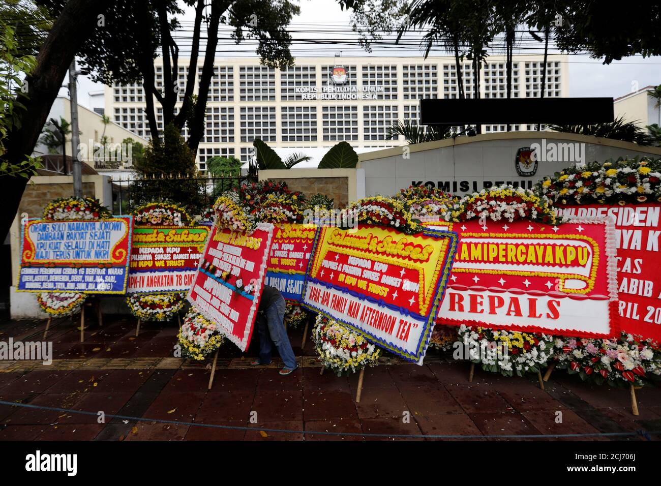 A worker arranges flower wreaths and congratulatory boards from people after this week's election outside General Election Commission (KPU) headquarters in Jakarta, Indonesia, April 21, 2019. REUTERS/Willy Kurniawan Stock Photo
