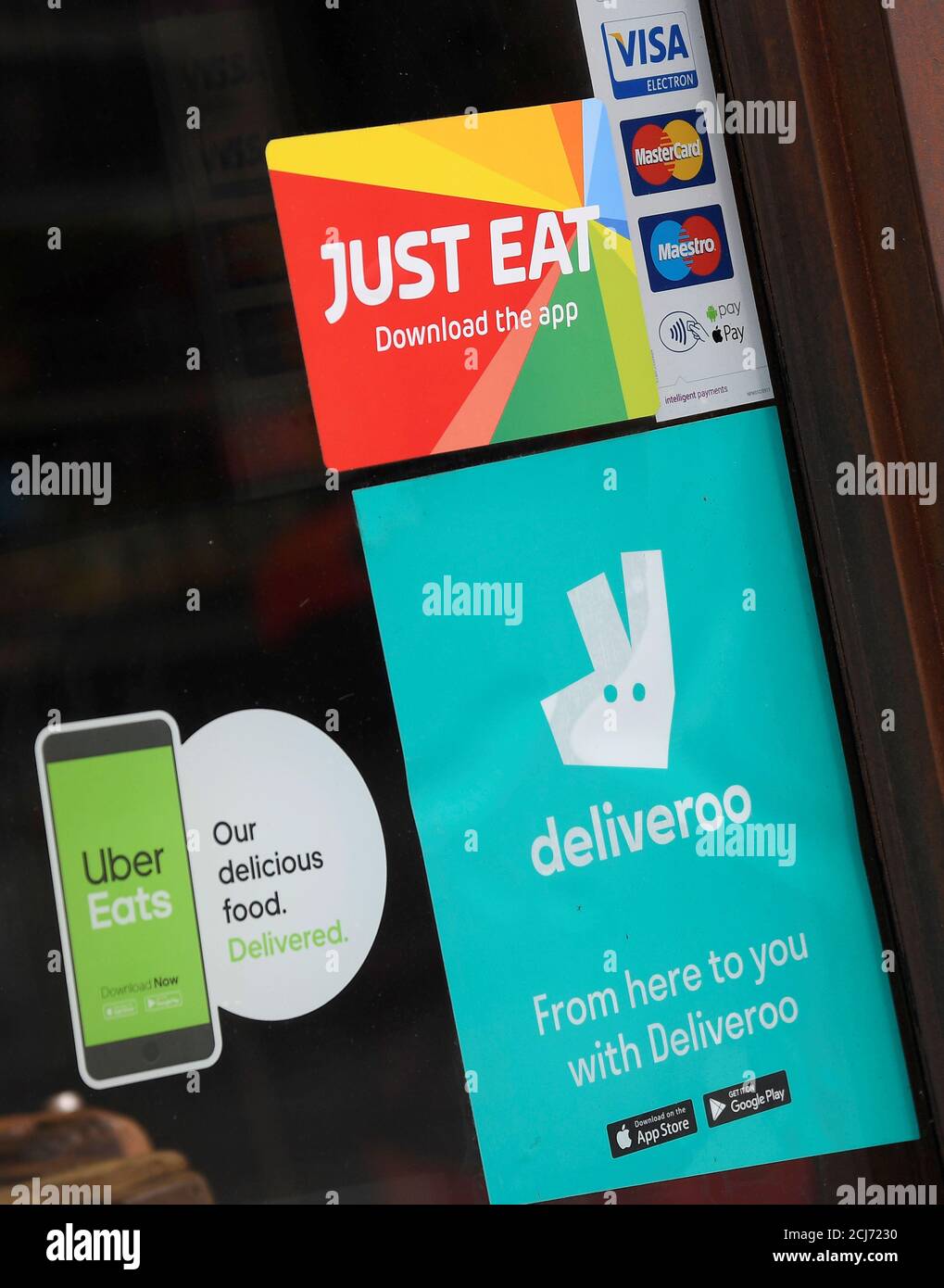 Signage For Just Eat Is Seen Next To Uber Eats And Deliveroo Advertisements On The Window Of A Restaurant In London Britain August 5 2019 Reuters Toby Melville Stock Photo Alamy