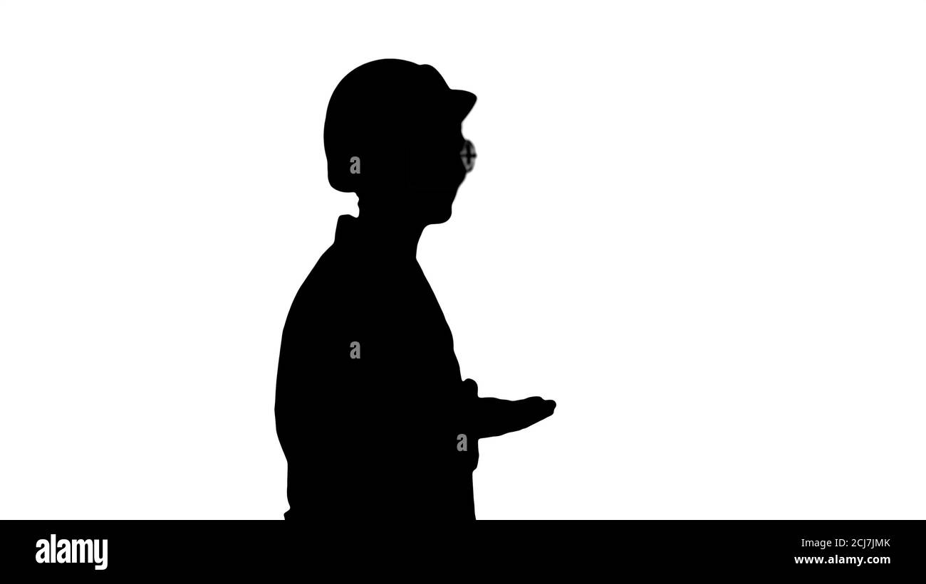 Silhouette Young scientist in lab coat and hardhat walking and s Stock Photo