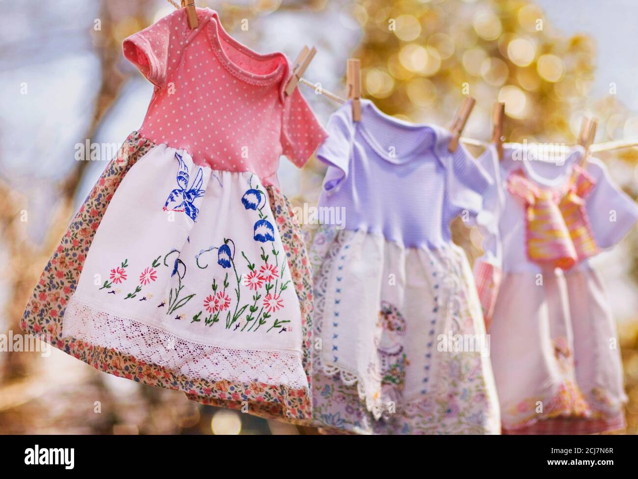 Young girl's vintage dresses on a clothesline outdoors Stock Photo - Alamy