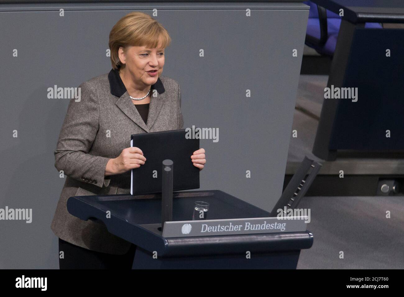 German Chancellor Angela Merkel delivers a government policy statement before the German lower house of parliament, the Bundestag, in Berlin, December 13, 2012. REUTERS/Thomas Peter (GERMANY - Tags: POLITICS) Stock Photo