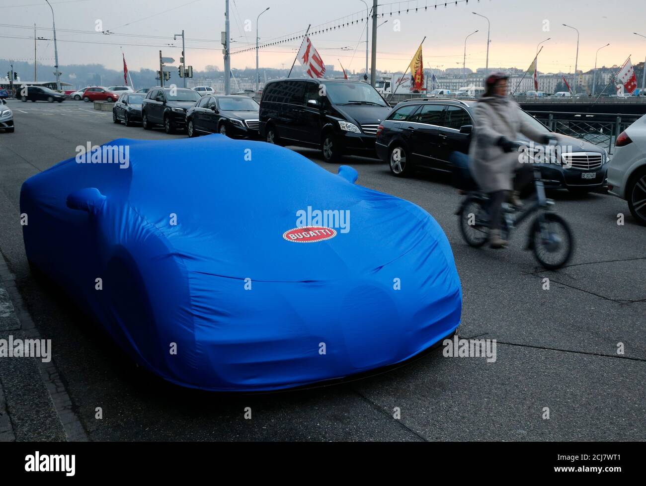 A cyclist drives past a covered Bugatti Chiron model car parked outside a  hotel in Geneva, Switzerland, March 11, 2016. REUTERS/Denis Balibouse Stock  Photo - Alamy