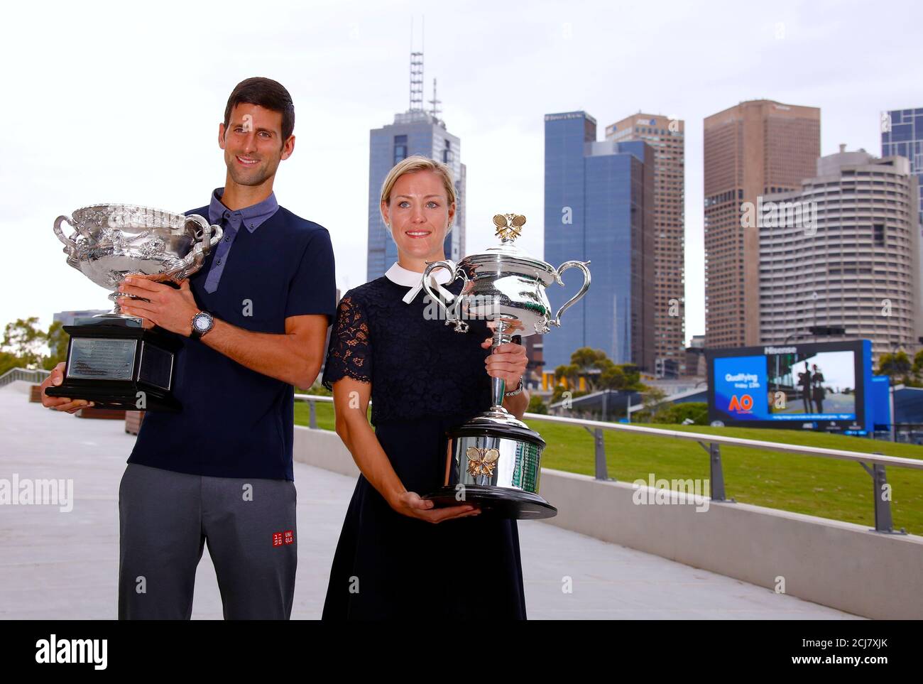 Current Australian Open tennis champions Serbia's Novak Djokovic and  Germany's Angelique Kerber stand together as they