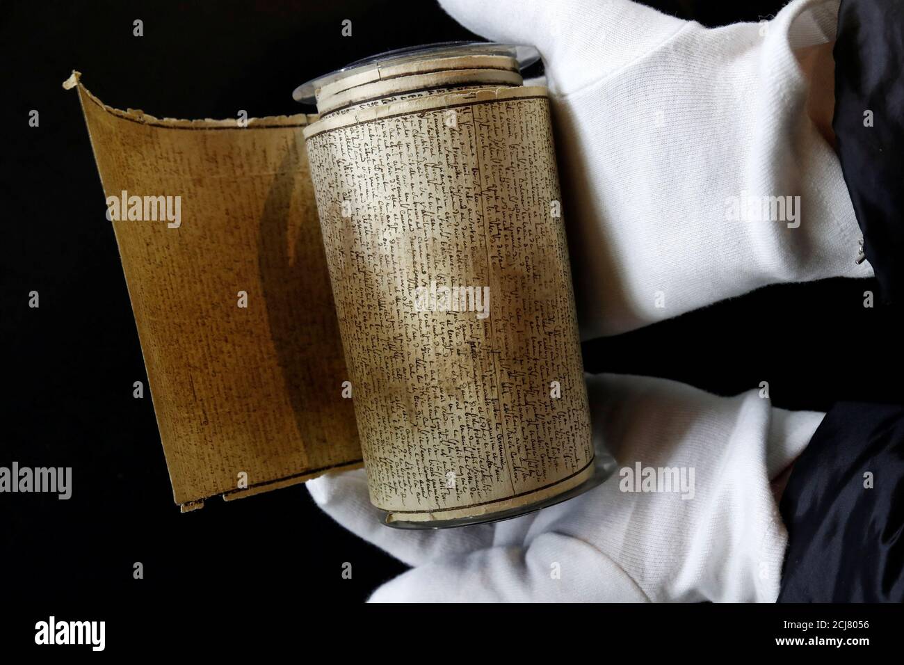 An employee displays the Marquis de Sade's original rolled manuscript  called Le Rouleau de la Bastille of 