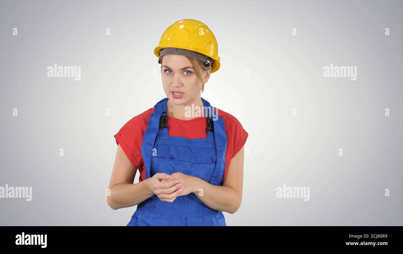 Construction female worket explaining her ideas to camera on gra Stock Photo