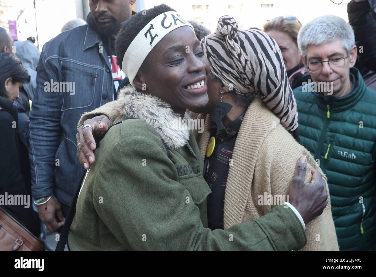 Therese Patricia Okoumou is embraced after her sentencing for conviction on attempted scaling of the Statue of Liberty to protest the U.S. immigration policy, outside a federal court in New York, U.S., March 19, 2019. REUTERS/Shannon Stapleton Stock Photo