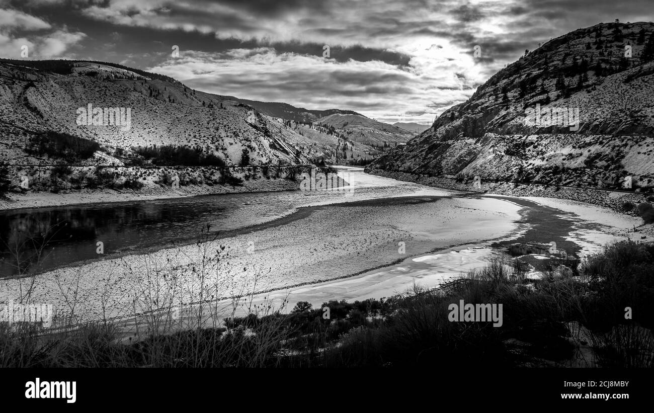 Black and White Photo of Sunset over the Winter Landscape of the semi arid Thompson River and the Trans Canada Highway in central British Columbia Stock Photo
