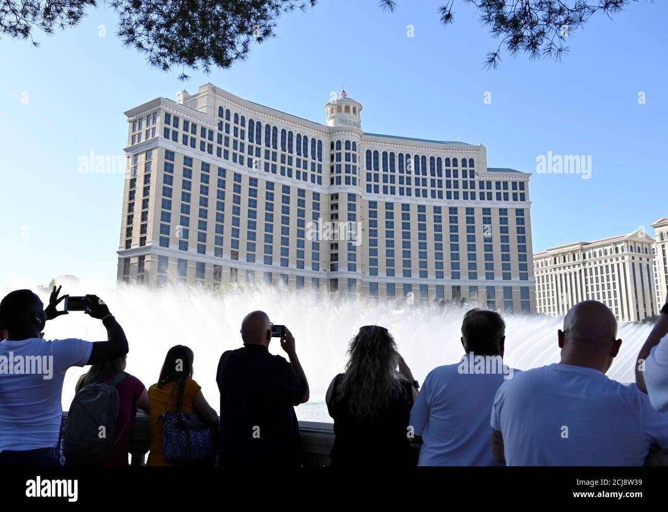 Tourists watch the fountain show at the Bellagio hotel and casino after MGM Resorts International announced it was selling the resort and Circus Circus in separate deals in Las Vegas, Nevada, U.S. October 15, 2019.  REUTERS/David Becker Stock Photo