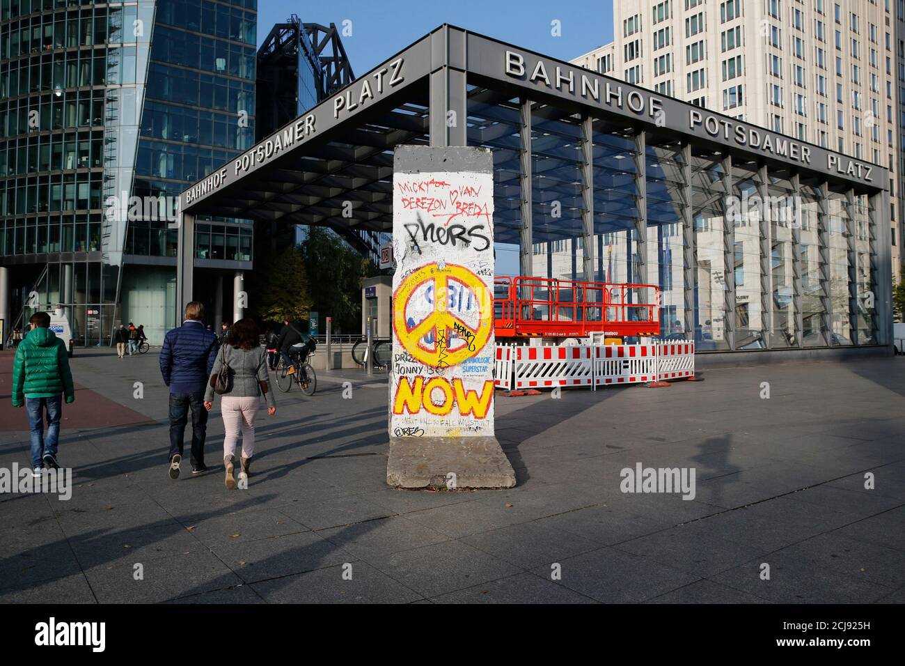 People Walk Past A Segment Of The Former Berlin Wall At Potsdamer Platz Square In Berlin October 29 14 On November 9 Germany Will Celebrate The 25th Anniversary Of The Fall Of