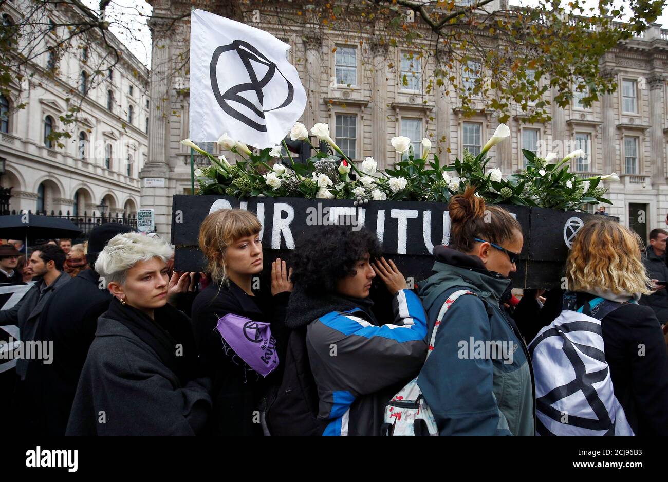 Demonstrators carry a mock coffin past Downing Street, during an Extinction Rebellion protest, central London, Britain November 24, 2018. REUTERS/Henry Nicholls Stock Photo