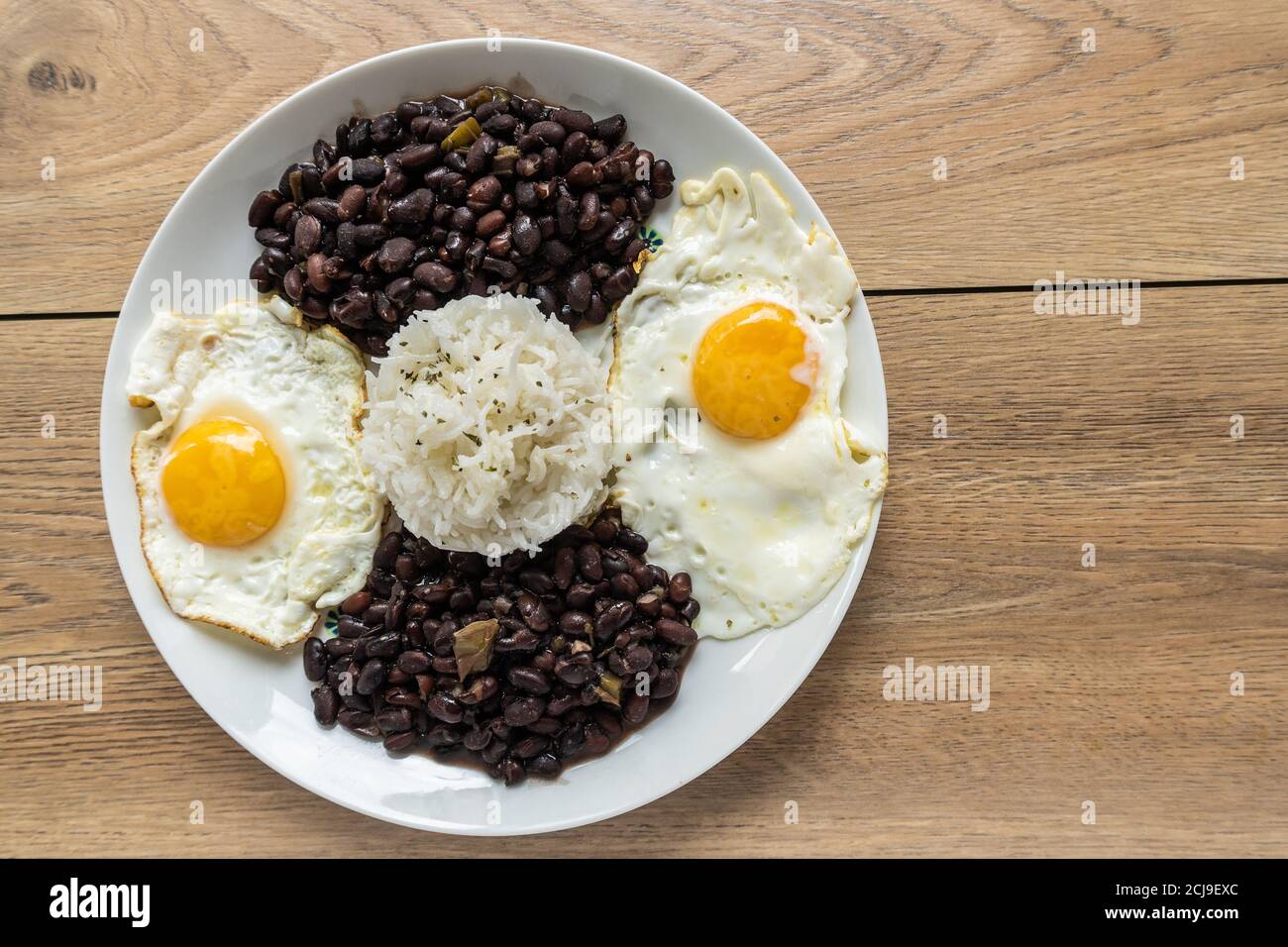 Dish of traditional Cuban cuisine with black beans, rice, and eggs Stock Photo