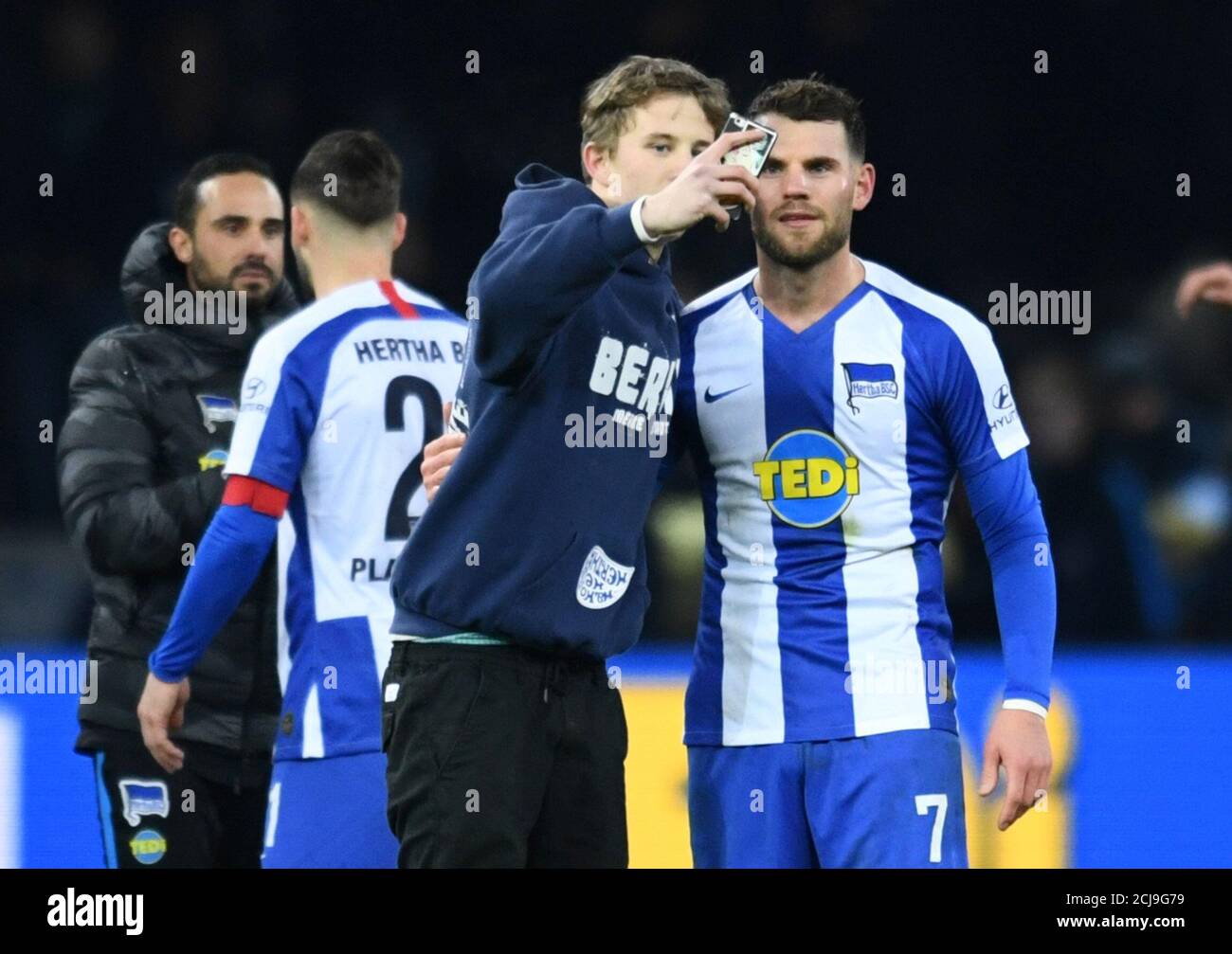 Soccer Football - Bundesliga - Hertha BSC v Borussia Moenchengladbach -  Olympiastadion, Berlin, Germany - December 21, 2019 Hertha BSC's Eduard  Lowen poses for a selfie with a fan on the pitch