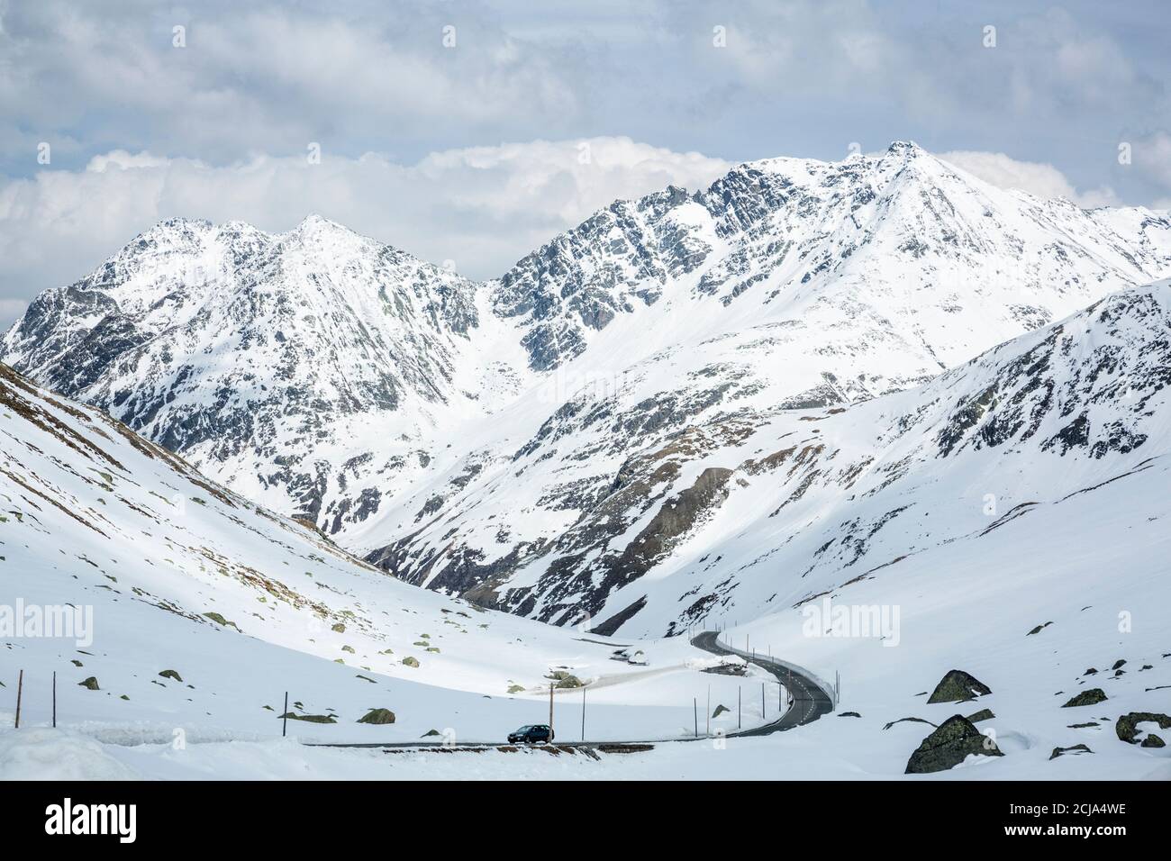 High mountain highway, with snow around, Fluela Pass, Switzerland. Stock Photo