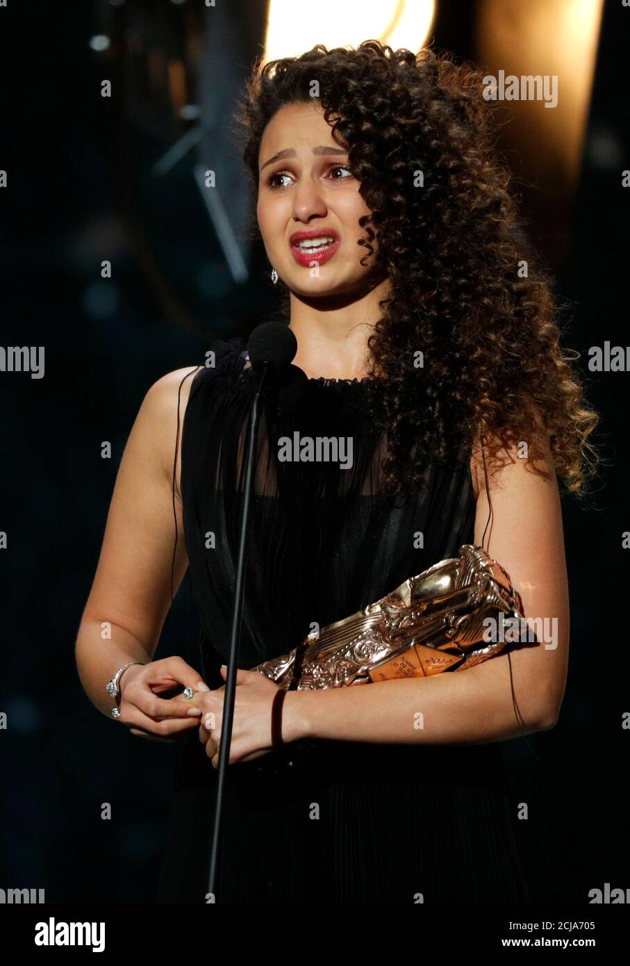 Actress Oulaya Amamra cries as she receives the Best Female Award for her role in the