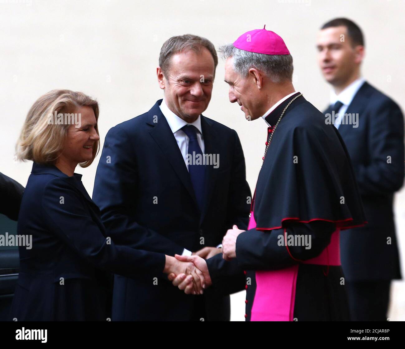 Archbishop Georg Ganswein greets European Council President Donald Tusk and his wife Malgorzata Tusk, as they arrive for a meeting with Pope Francis at the Vatican March 24, 2017.  REUTERS/Alessandro Bianchi Stock Photo