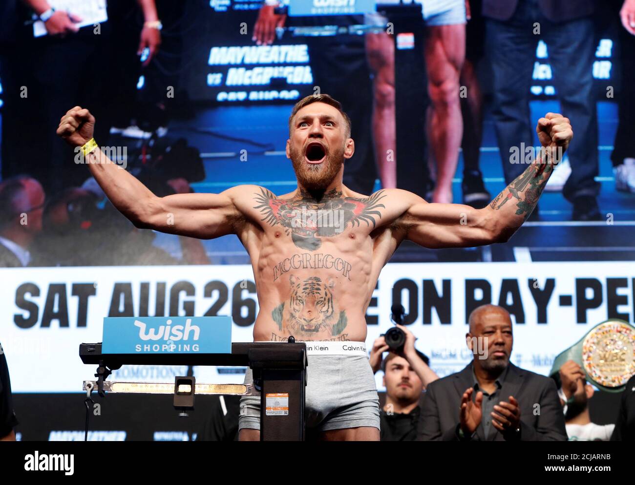UFC lightweight champion Conor McGregor of Ireland poses on the scale  during his official weigh-in at T-Mobile Arena in Las Vegas, Nevada, U.S.  on August 25, 2017. REUTERS/Steve Marcus Stock Photo -