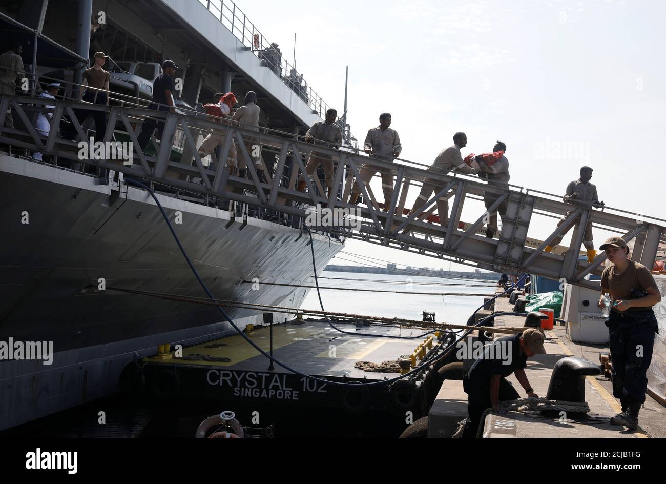 Port workers load food supplies onto the USS Blue Ridge (LCC 19), flagship of the U.S. Navy's 7th Fleet, at Changi Naval Base in Singapore May 9, 2019. REUTERS/Edgar Su Stock Photo
