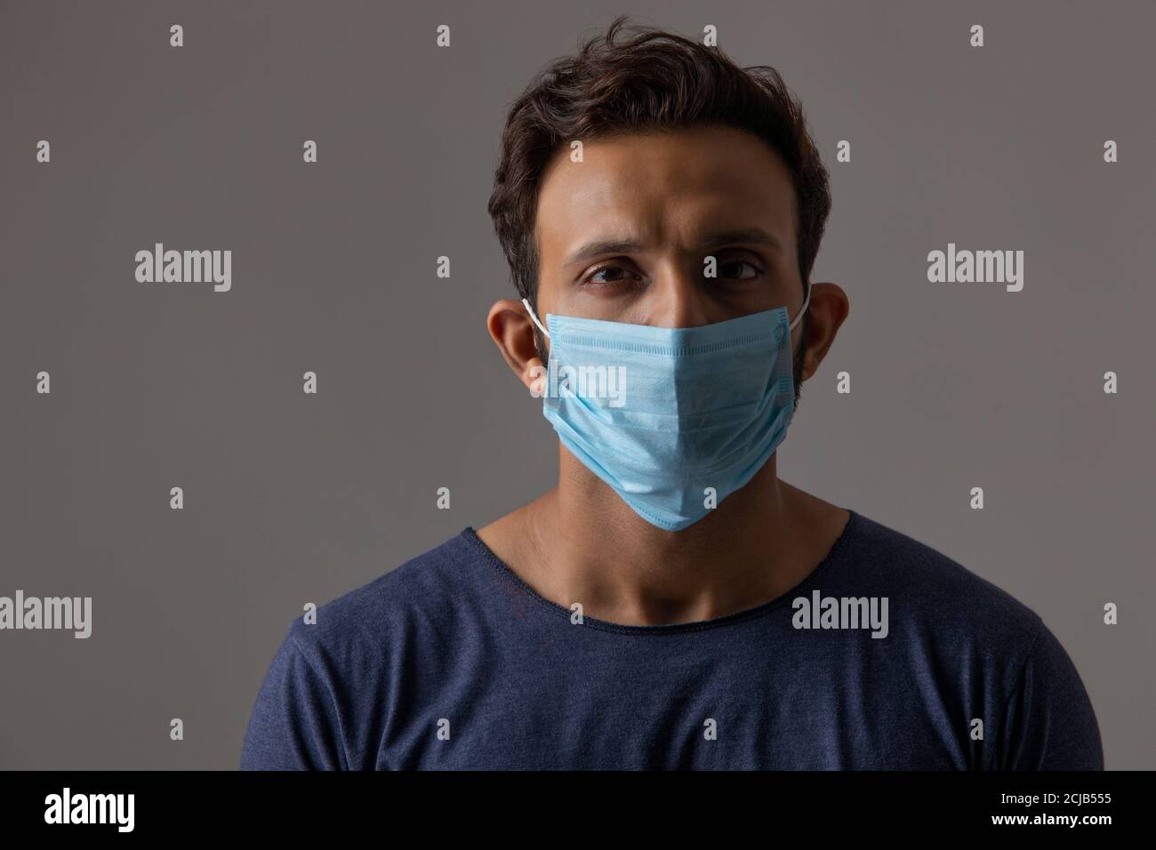 Portrait of a man with his face covered in a mask Stock Photo - Alamy