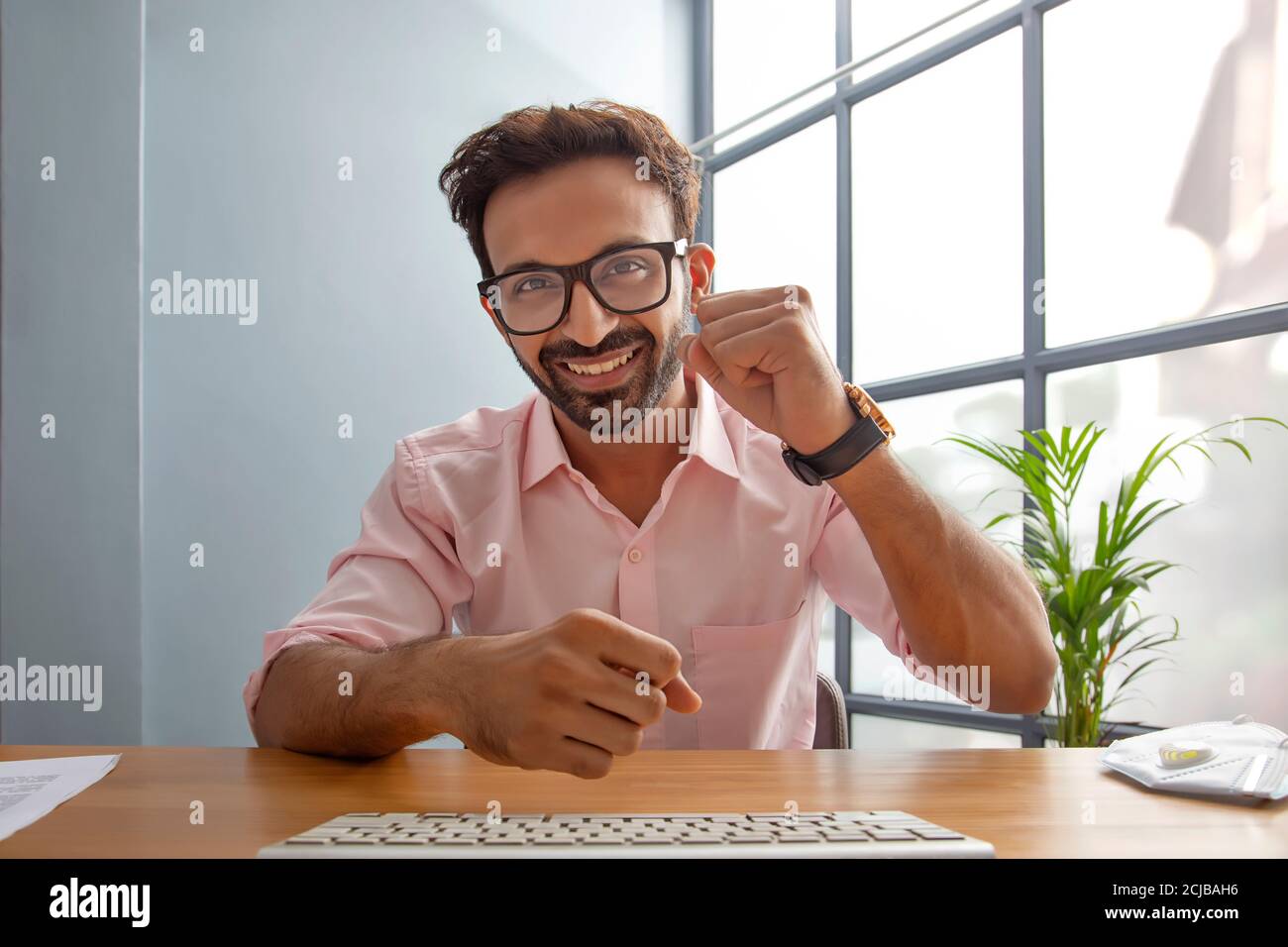 Young man motivating his employees on a video call Stock Photo
